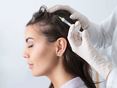Dermatologist performing injectable treatment for hair regrowth and skin whitening at clinic in Pune